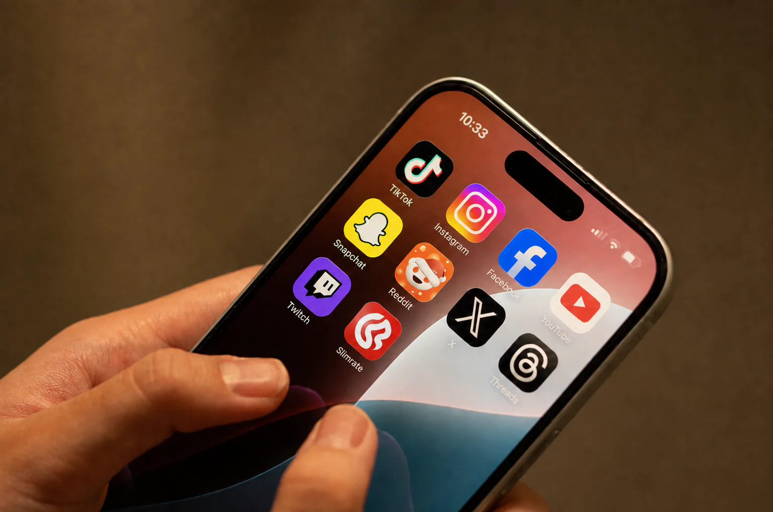 Mano sosteniendo un teléfono con el ícono de la app móvil de Slimrate en pantalla