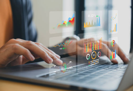 Business analytics charts displayed over a laptop workspace.