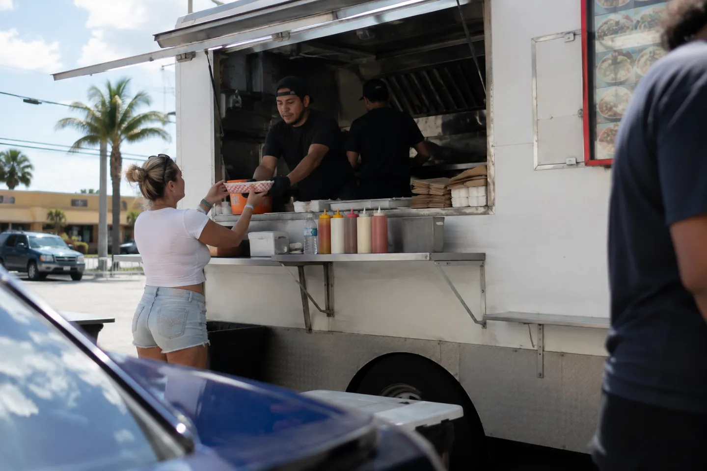 Customer receiving an order at a food truck window