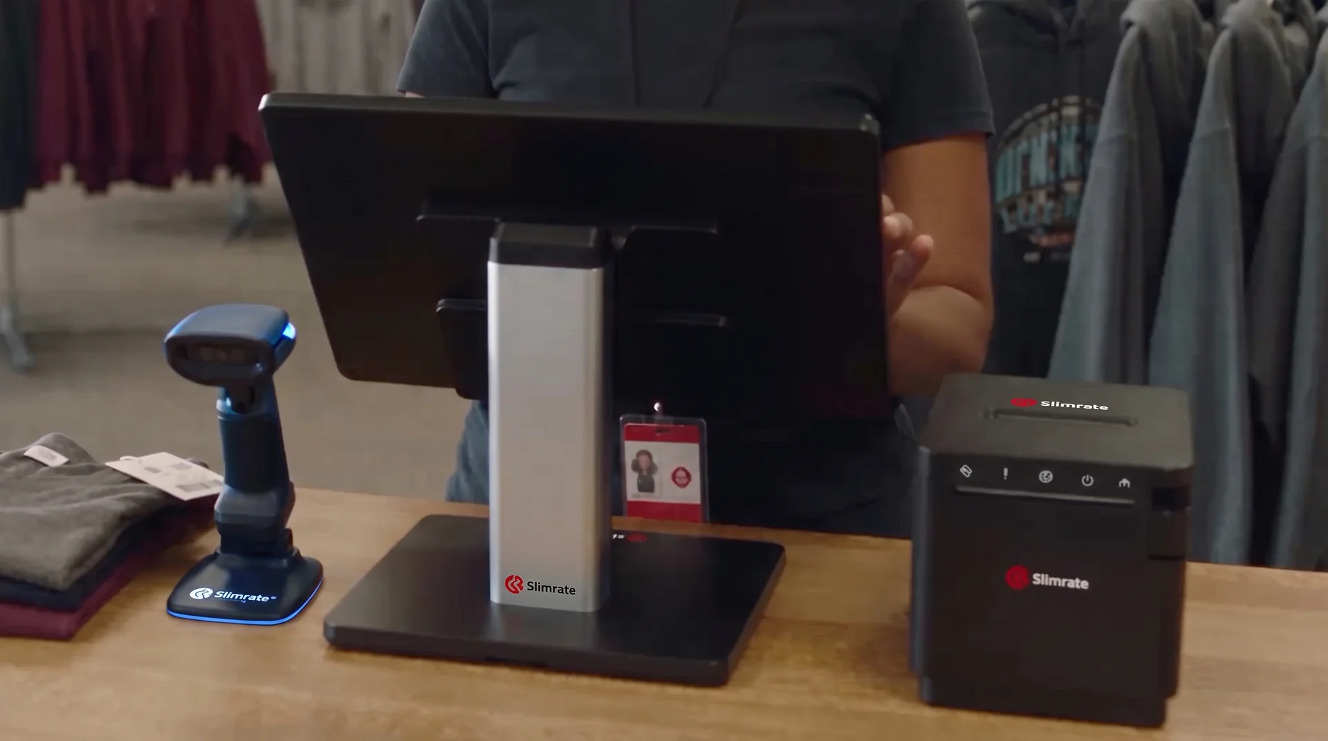 Slimrate retail POS terminal, barcode scanner, and receipt printer at a clothing store counter