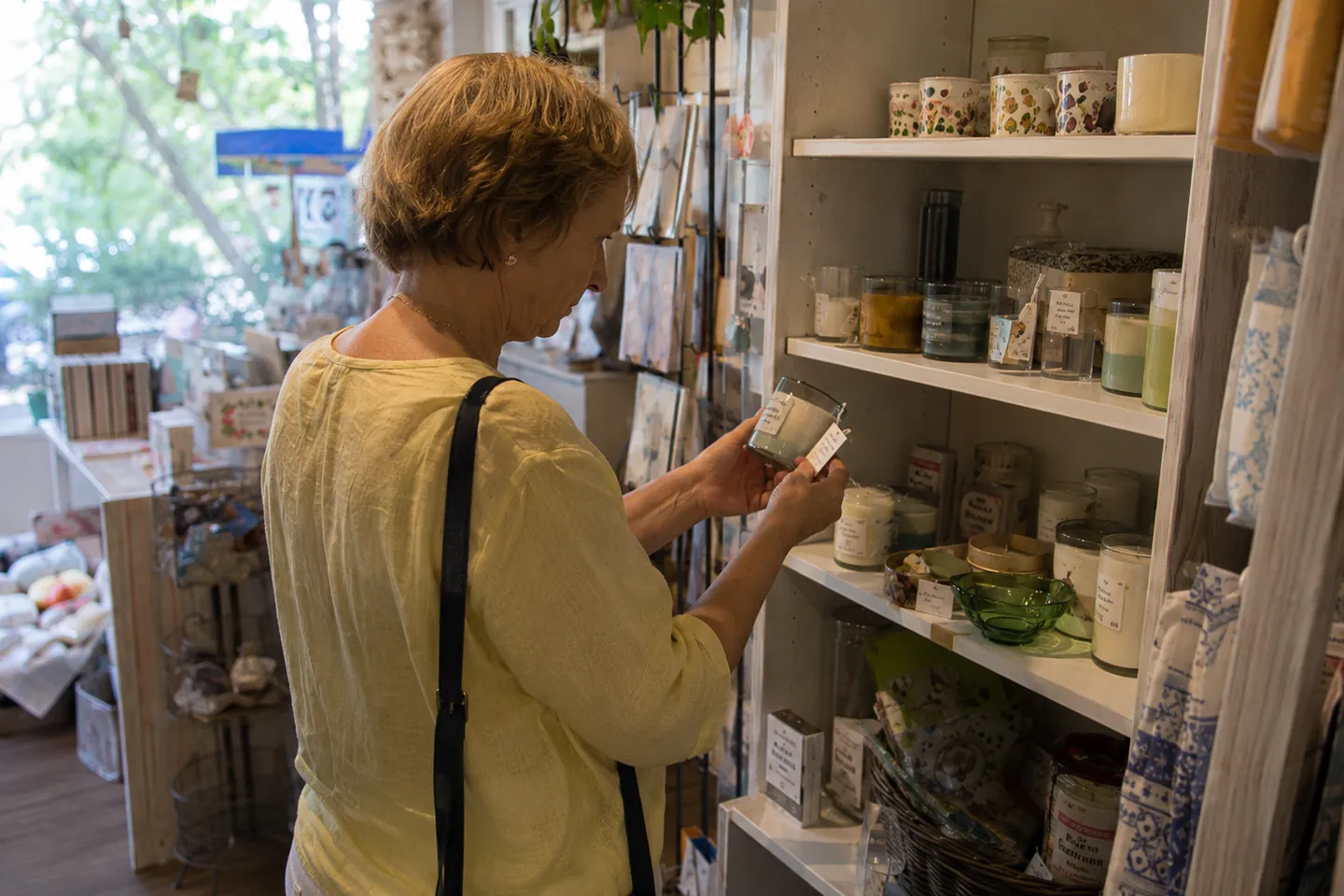 Shopper examining a candle in a gift shop